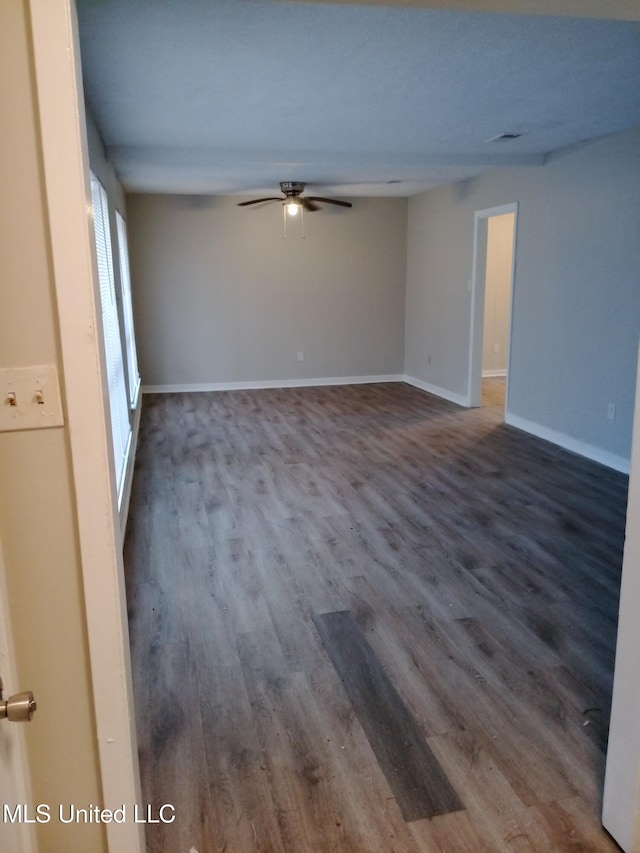 spare room with hardwood / wood-style floors and ceiling fan