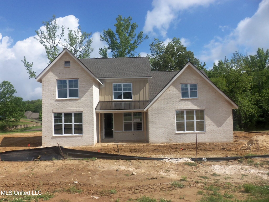 9884 Cypress Willow Cv, Olive Branch, MS 38654 - back of house with a standing seam roof, brick siding, board and batten siding, and metal roof