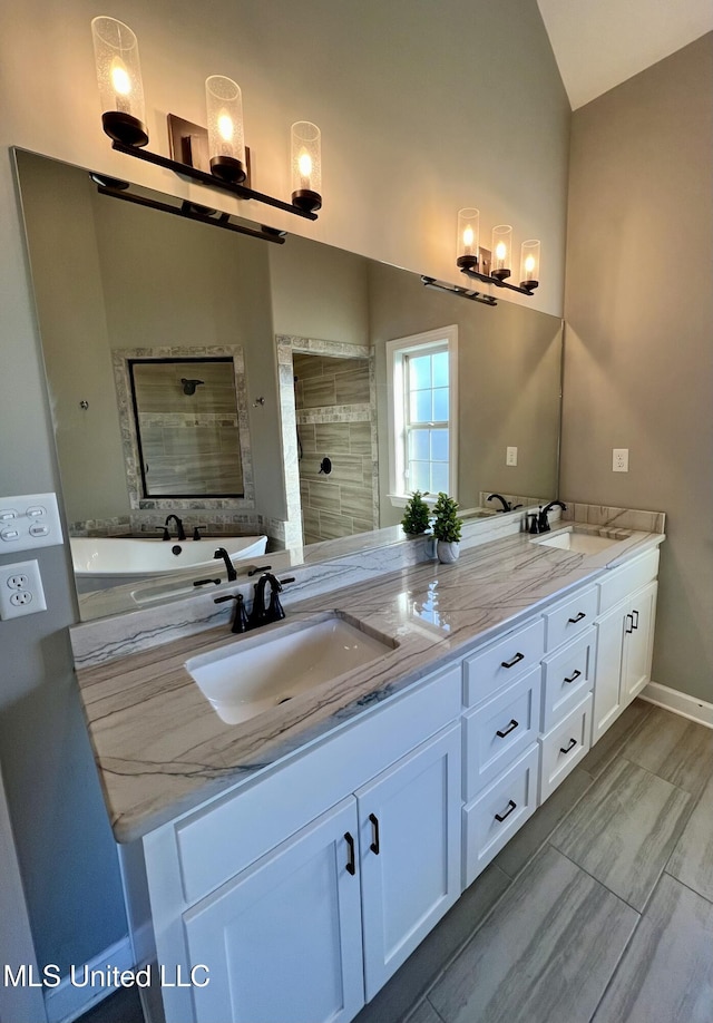 bathroom featuring vanity, vaulted ceiling, and walk in shower