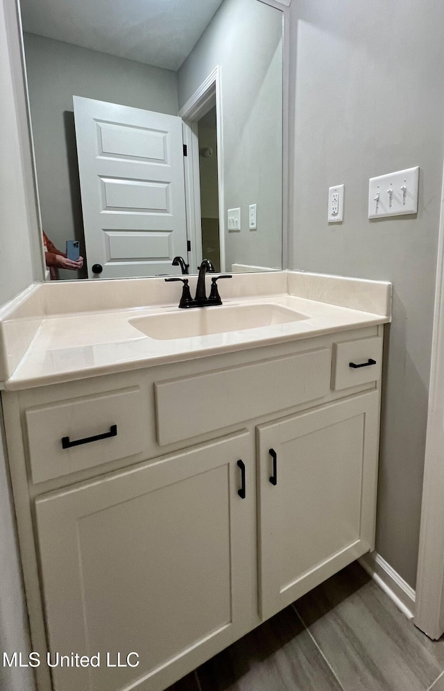 bathroom with vanity and wood-type flooring