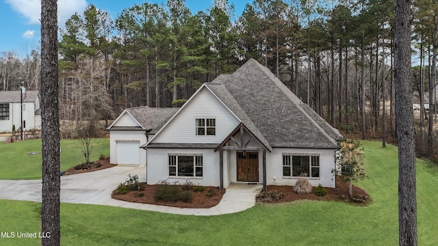 view of front of house with a garage and a front lawn