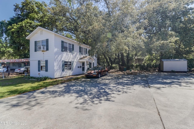 308 Rodenberg Ave, Biloxi, MS 39531 - view of home's exterior with concrete driveway, an outbuilding, and a shed