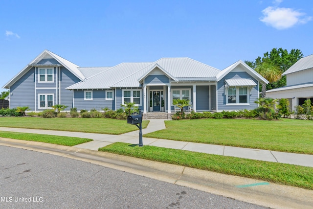 140 Seaside Dr, Ocean Springs, MS 39564 - view of front of home with a front lawn, covered porch, and metal roof