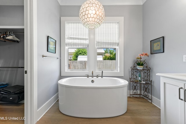 140 Seaside Dr, Ocean Springs, MS 39564 - full bathroom featuring baseboards, a freestanding tub, wood finished floors, and vanity