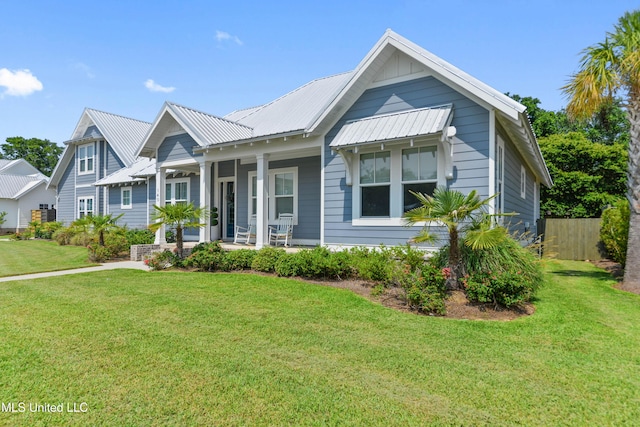 140 Seaside Dr, Ocean Springs, MS 39564 - view of front facade with a porch and metal roof