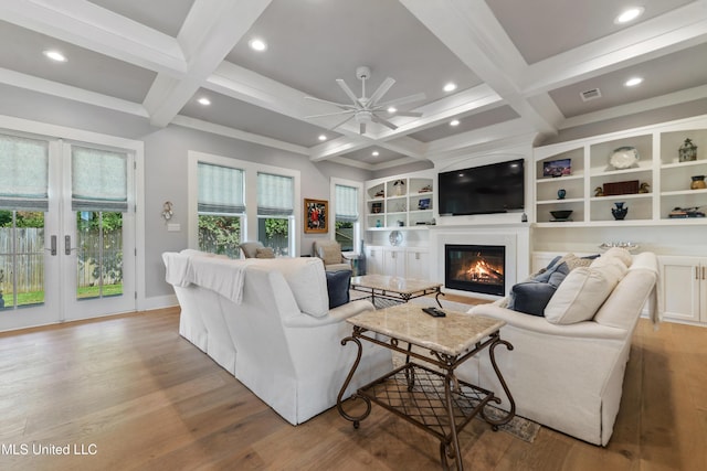 140 Seaside Dr, Ocean Springs, MS 39564 - living room featuring a ceiling fan, light wood-type flooring, coffered ceiling, beam ceiling, and a glass covered fireplace