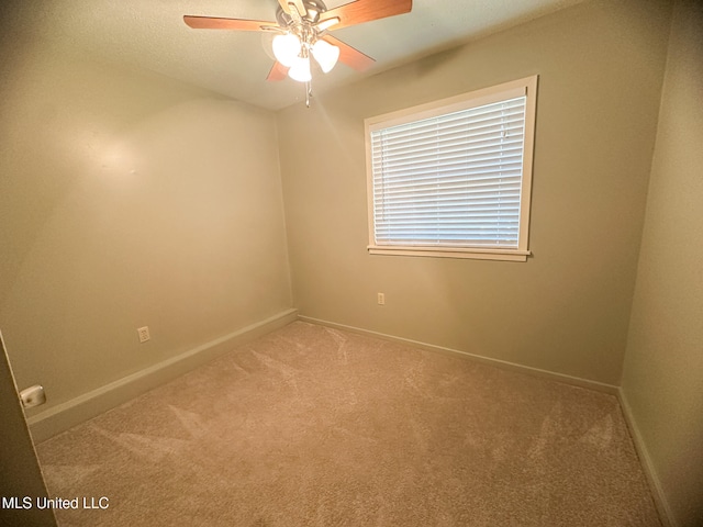 empty room with carpet flooring and ceiling fan