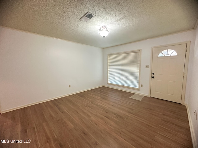 entryway with dark hardwood / wood-style floors and a textured ceiling