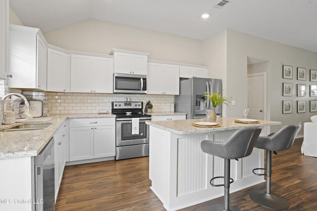 12 Mercer Dr, Petal, MS 39465 - kitchen featuring appliances with stainless steel finishes, a sink, a center island, dark wood-type flooring, and white cabinets