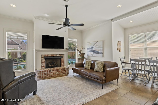 tiled living area featuring recessed lighting, ceiling fan, a fireplace, and ornamental molding