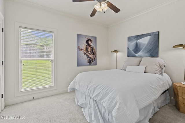 carpeted bedroom featuring crown molding, multiple windows, ceiling fan, and baseboards