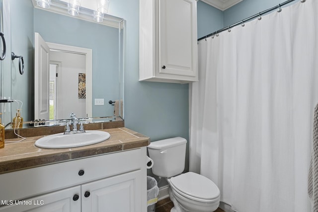 bathroom featuring toilet and vanity