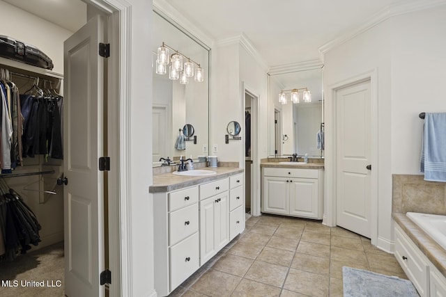 full bathroom with tile patterned floors, two vanities, a spacious closet, a tub, and crown molding