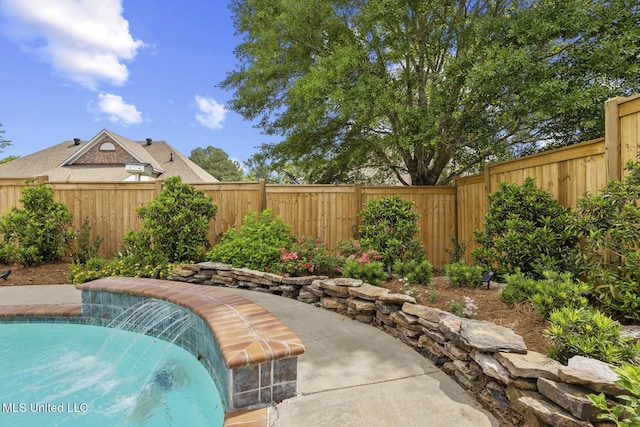 view of swimming pool with a fenced backyard and a patio area