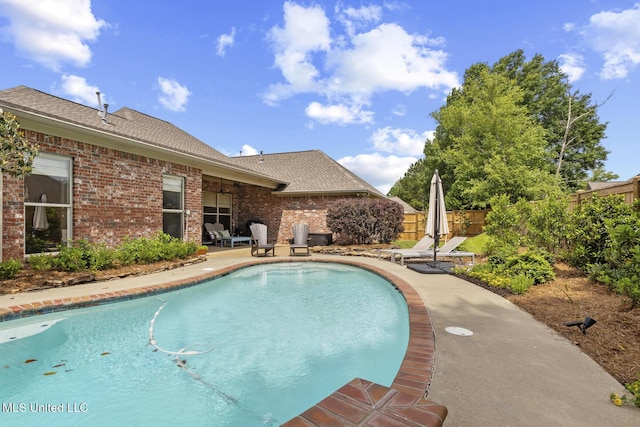 view of pool with fence and a patio