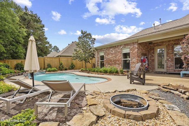 view of pool with a patio, a fire pit, and a fenced backyard