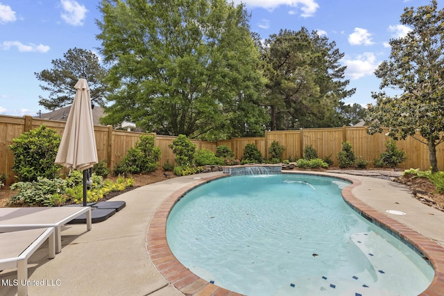 view of pool with a fenced backyard