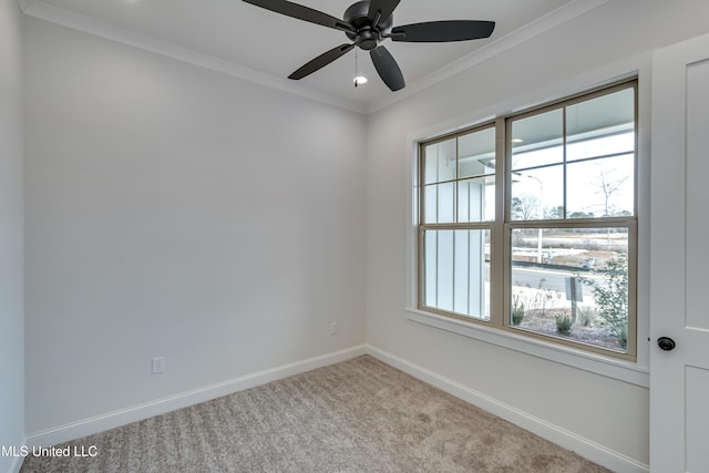 spare room with ceiling fan, ornamental molding, and light carpet