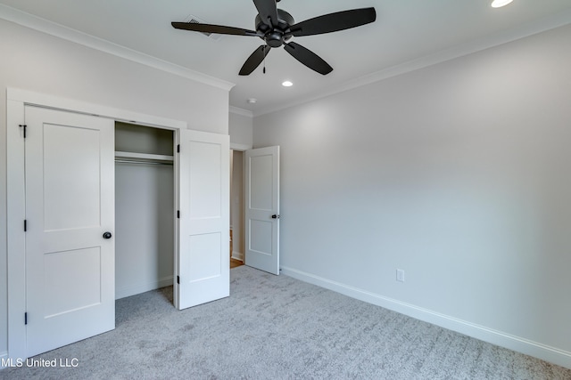 unfurnished bedroom with ceiling fan, light carpet, a closet, and ornamental molding