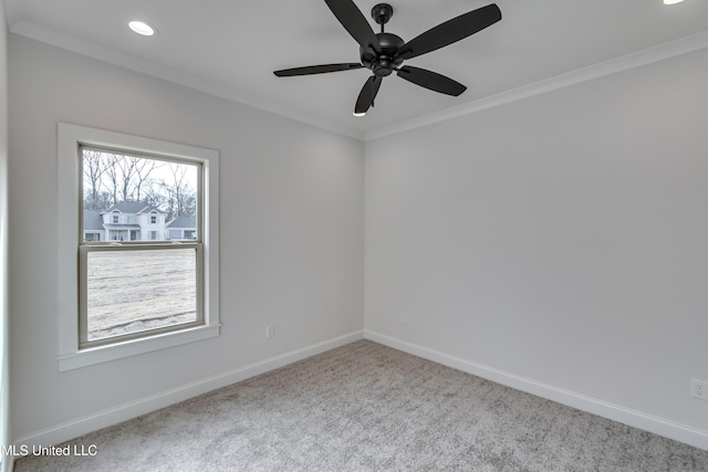 empty room featuring ceiling fan, crown molding, and light carpet