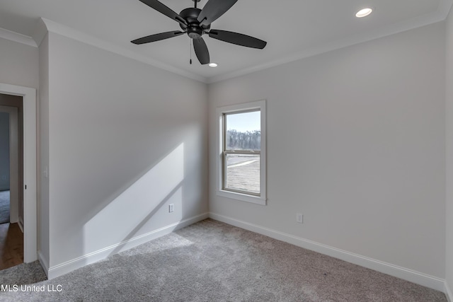 carpeted empty room featuring ceiling fan and crown molding