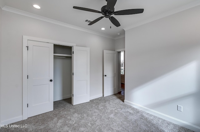 unfurnished bedroom featuring a closet, ceiling fan, carpet, and crown molding