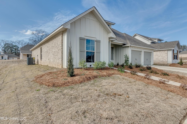 628 Cobalt Way, Brandon, MS 39042 - view of front of house with board and batten siding, a garage, brick siding, and concrete driveway