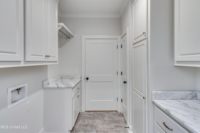 washroom with washer hookup, ornamental molding, and cabinets