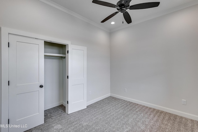 unfurnished bedroom with a closet, ceiling fan, carpet, and crown molding