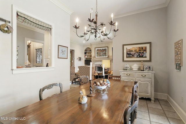 dining area featuring an inviting chandelier, light tile patterned floors, crown molding, and built in features