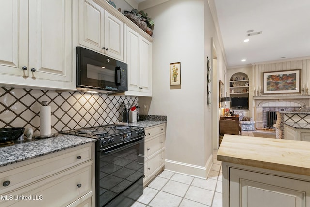 kitchen featuring black appliances, light tile patterned floors, light stone countertops, and crown molding