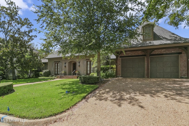 view of front of property featuring a garage and a front yard