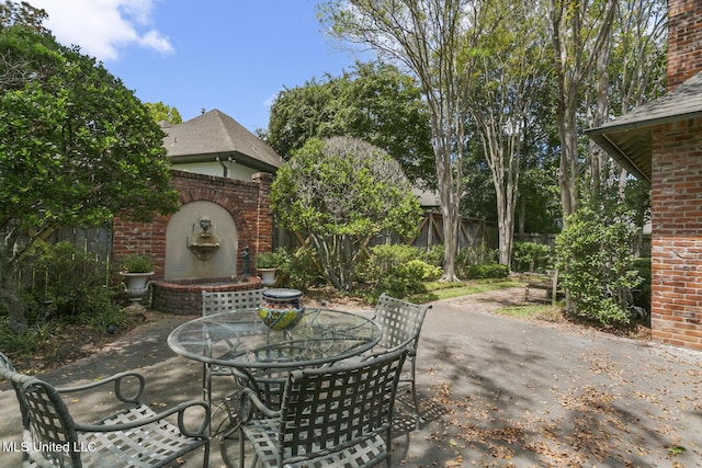 view of patio with an outdoor brick fireplace