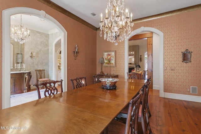 dining space with dark hardwood / wood-style floors and a notable chandelier