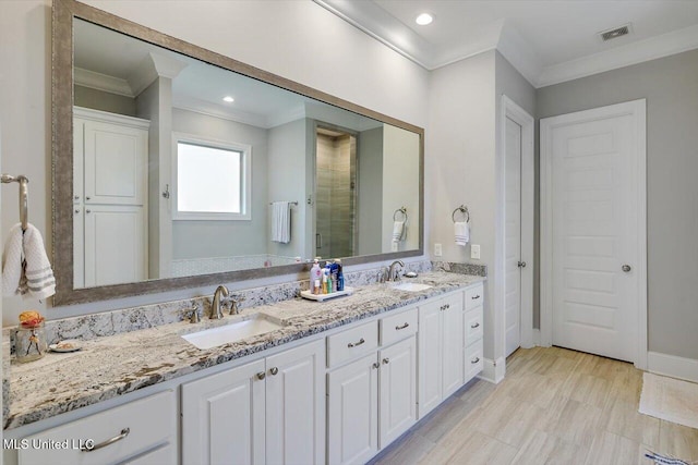 full bath with visible vents, a sink, and ornamental molding