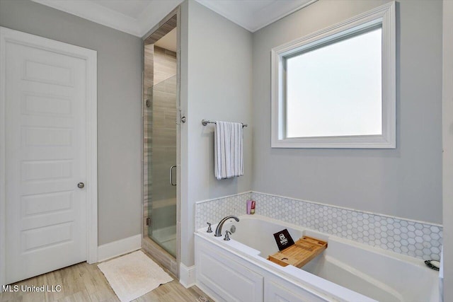 full bath featuring a shower stall, a bath, and wood finished floors