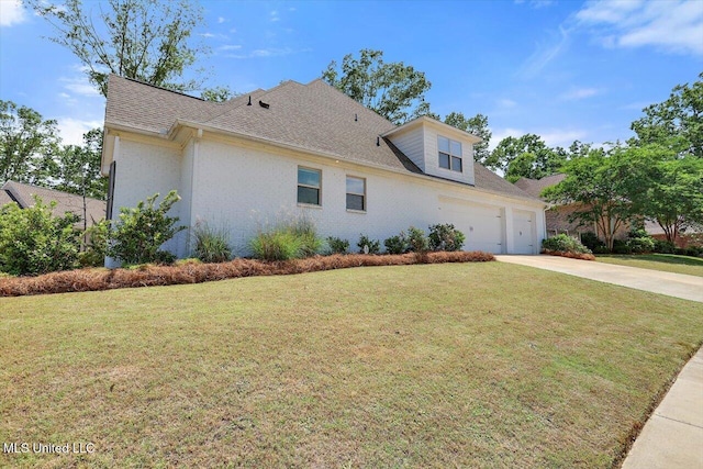 view of front of home with a shingled roof, an attached garage, concrete driveway, and a front lawn
