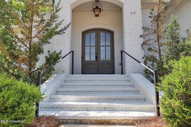property entrance with french doors and stucco siding