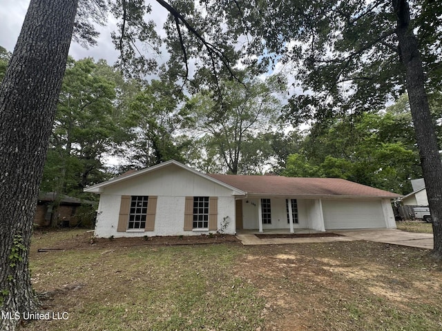 105 Poplar Dr, Brandon, MS 39047 - view of front facade featuring driveway, a garage, a porch, and brick siding