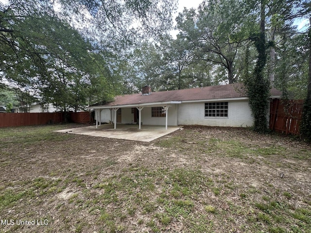105 Poplar Dr, Brandon, MS 39047 - back of house featuring a patio and a chimney