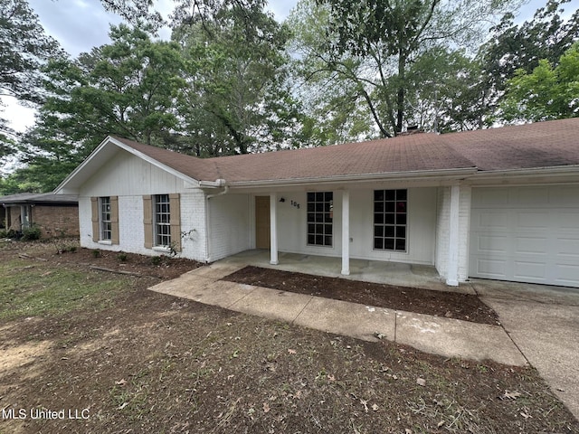 105 Poplar Dr, Brandon, MS 39047 - ranch-style house featuring concrete driveway, a garage, brick siding, covered porch, and roof with shingles