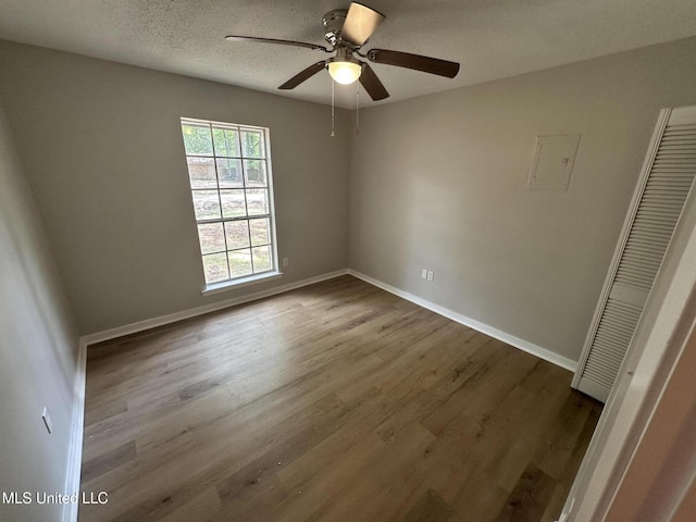 105 Poplar Dr, Brandon, MS 39047 - spare room featuring wood finished floors, ceiling fan, and a textured ceiling