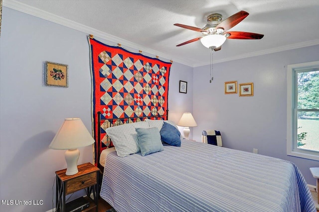 bedroom with ceiling fan, crown molding, and a textured ceiling