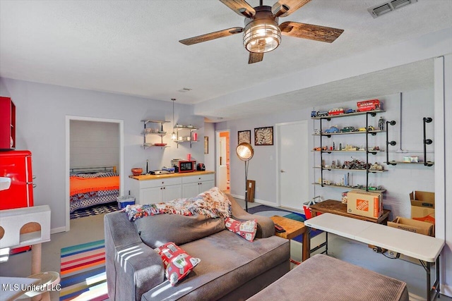 carpeted living room with a textured ceiling and ceiling fan