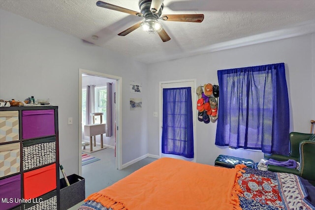 bedroom with ceiling fan and a textured ceiling