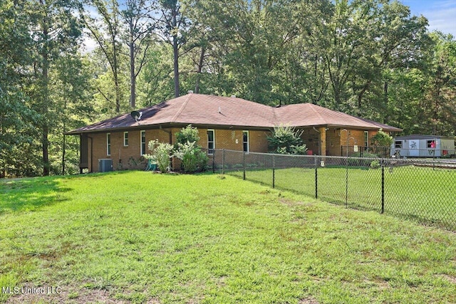 exterior space featuring central air condition unit and a front lawn