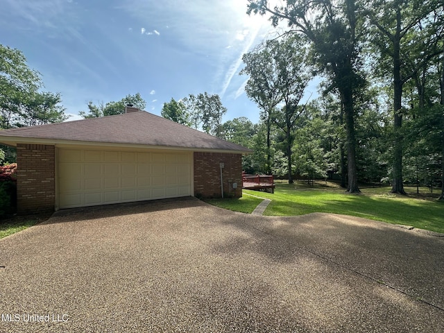 813 Eagles Nest Dr, Byram, MS 39272 - view of property exterior with brick siding, a yard, and a detached garage