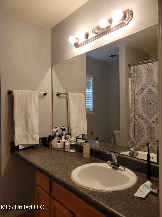 bathroom with vanity and toilet