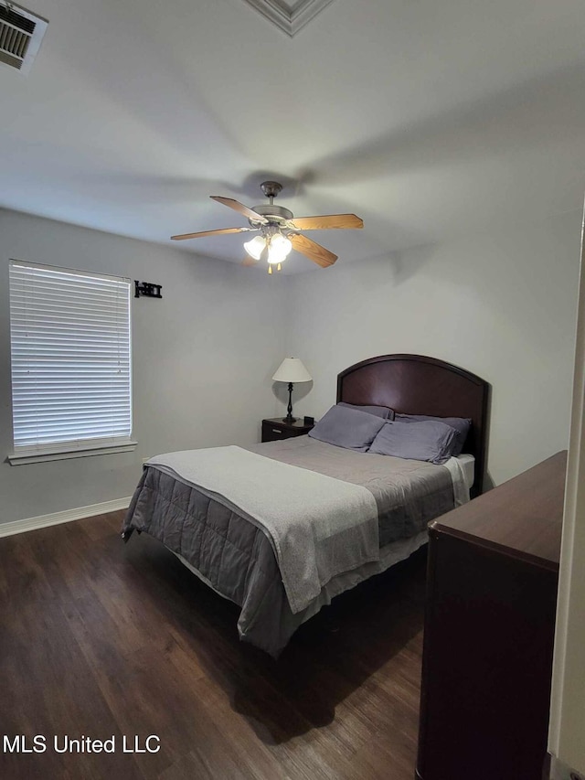 bedroom with ceiling fan and dark hardwood / wood-style flooring