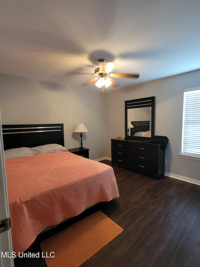 bedroom featuring ceiling fan and dark wood-type flooring